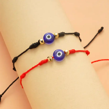 Black and red adjustable evil eye bracelets with gold beads for protection and spiritual balance.