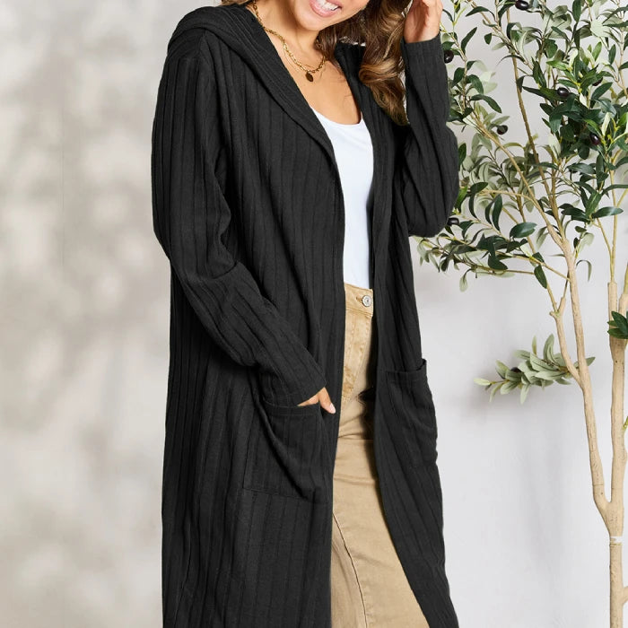 Cozy black ribbed hooded cardigan with pockets styled with white tank top and khaki pants for casual fall fashion