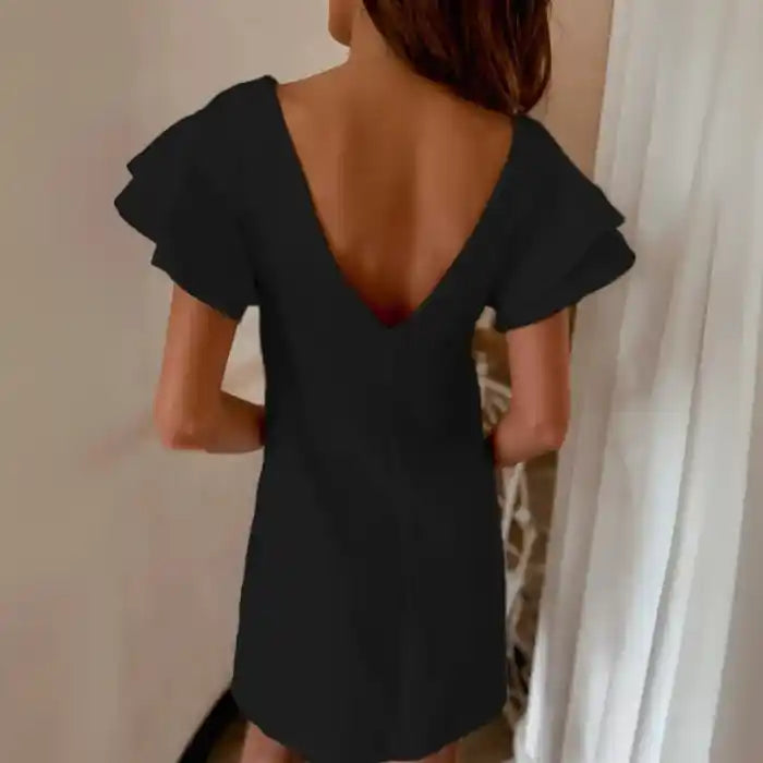 Black ruffle sleeve shift dress with v-back detail and soft fluttering layered sleeves.