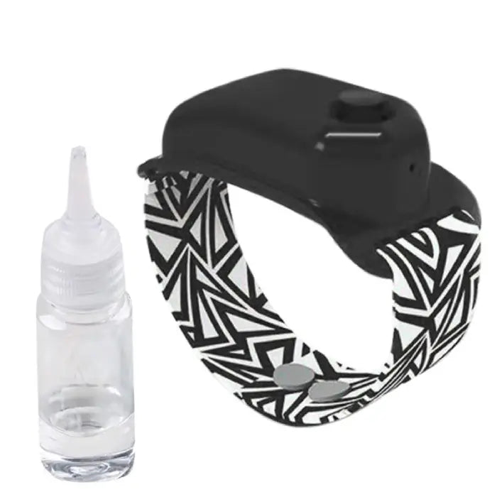 Black hand sanitizer wristband with geometric strap design and a refillable dispenser bottle.