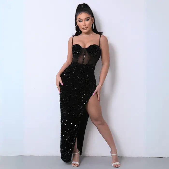 Black sequin mesh evening gown featuring a sheer corset top, high slit, and curve-hugging fit.