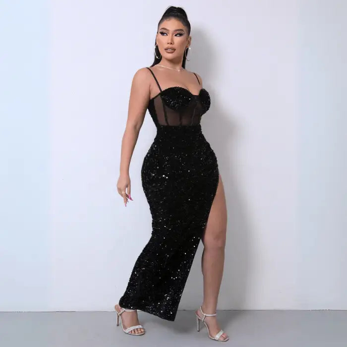 Black sequin spliced mesh dress with a thigh-high slit, sheer corset bodice, and spaghetti straps.