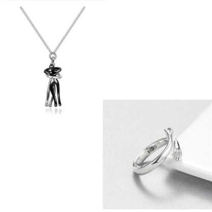 Black and silver couple hug pendant necklace showcasing a contemporary and artistic romantic jewelry design.