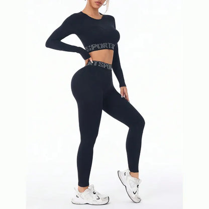 Seamless black workout set with long sleeve crop top and high-waisted leggings featuring sports text detail and white sneakers