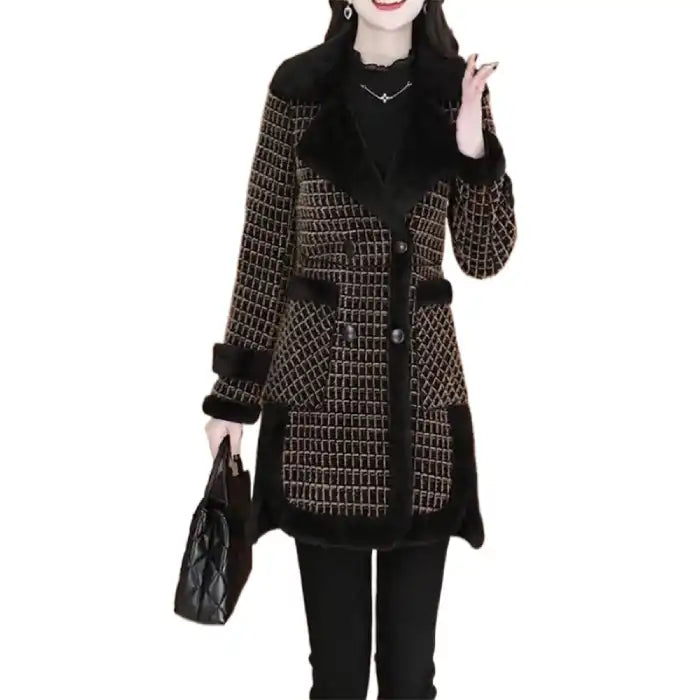 Black tweed coat with fur trim shows textured pattern, button closure, and plush fur details in angle view.