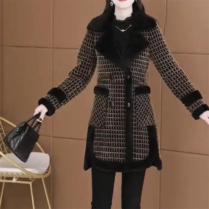 Black tweed coat with fur trim features geometric pattern, fur collar, cuffs, and hem in front view styling.