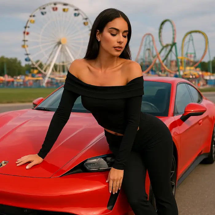 Black two piece outfit showcasing sculpted silhouette against sunset amusement park background with ferris wheel and luxury car