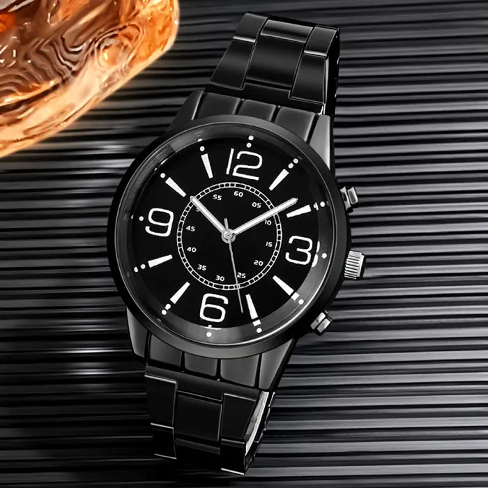 Modern black chronograph watch with bold numerals displayed against textured background with copper design element