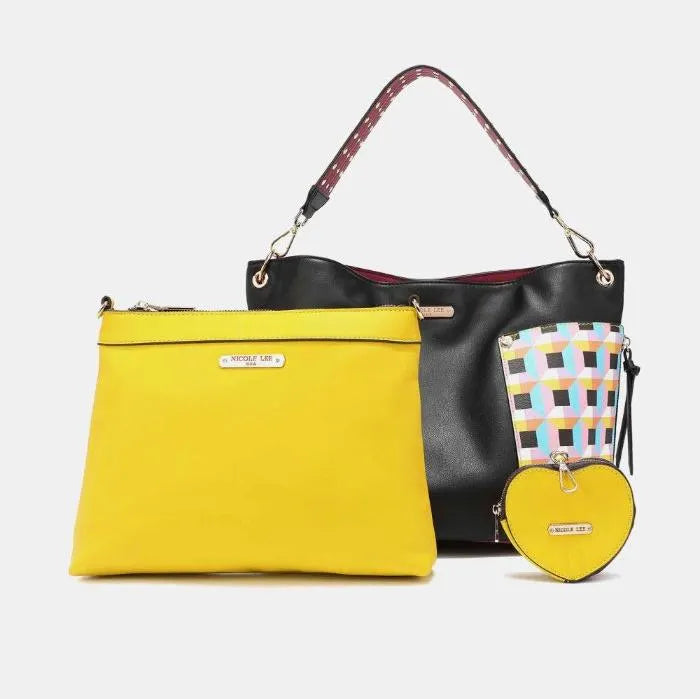 Black leather tote with yellow clutch and geometric pattern panels, includes matching heart-shaped accessory pouch