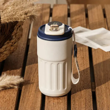 Blue accented smart coffee mug on wooden surface with rustic background and dried plants