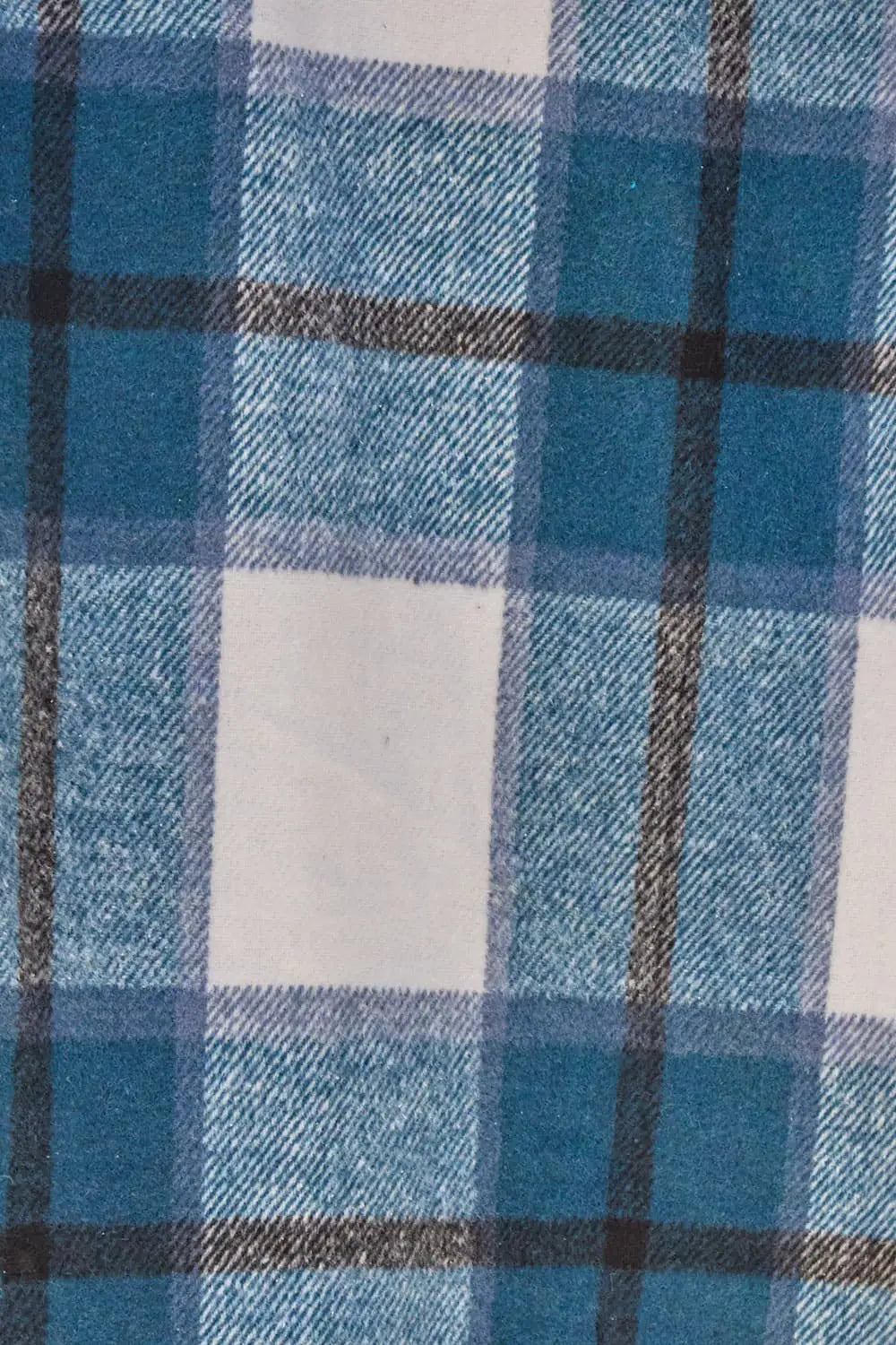 Close-up of blue and white plaid wool fabric showing its detailed texture and checkered pattern.