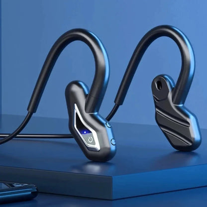 Black wireless headphones with ergonomic design on blue platform, showcasing sleek form and LED indicator