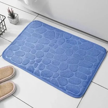 Soft textured blue bathroom mat, combines comfort and style.