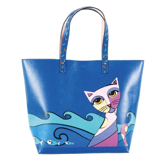 Artistic blue leather tote bag featuring whimsical cat illustration with ocean waves and fish design, perfect for casual fashion accessories