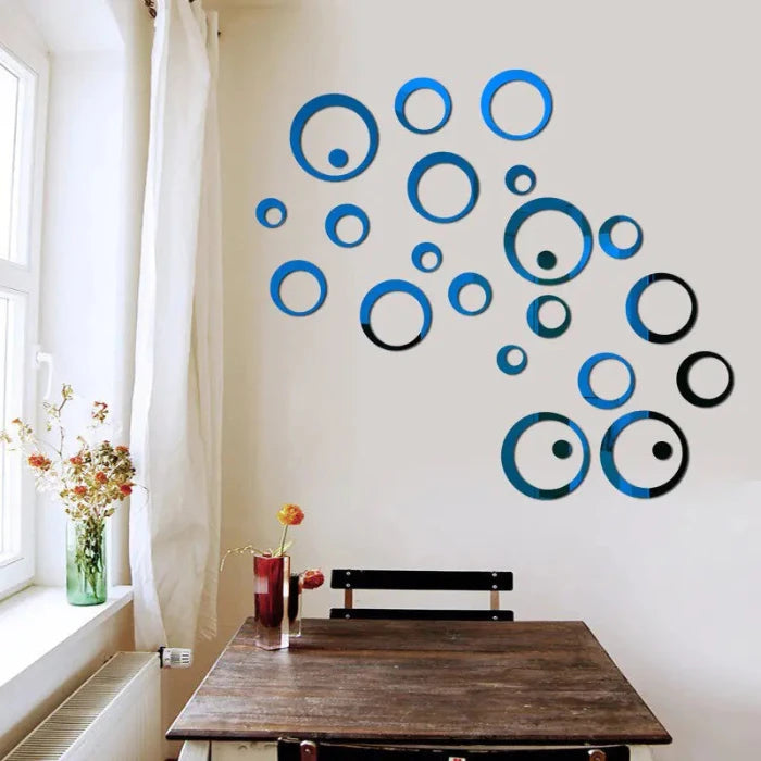 Set of round blue mirror in various sizes arranged in a scattered pattern on a white background for wall decoration near window with flower arrangement on table