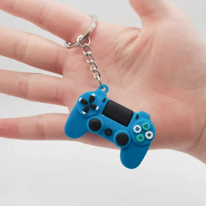 Blue game controller keychain displayed in hand, a trendy accessory for gamers and collectors.