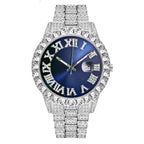 Silver watch featuring blue dial and Roman numerals, encrusted with diamonds.
