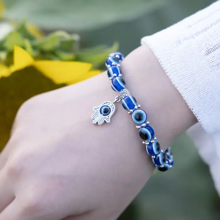 Blue evil eye bracelet with a silver Hamsa charm for Turkish protection and spiritual defense.