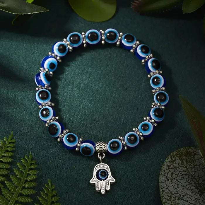 Close-up of a blue evil eye bracelet with a Hamsa hand charm, worn for Turkish protection.