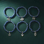 Set of six blue evil eye bracelets with silver charms for Turkish protection and spiritual energy.