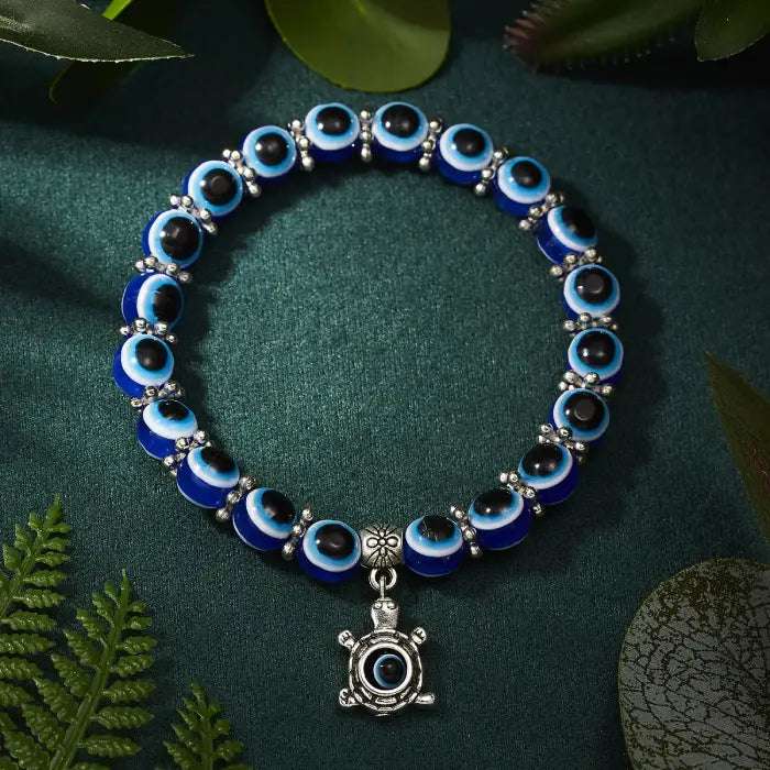 Blue evil eye bracelet with a turtle charm, representing protection and longevity in Turkish culture.