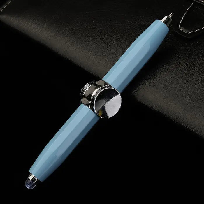 Blue fidget spinner pen with dual stylus tips placed on a black leather surface.