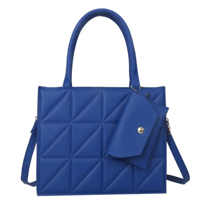 Blue geometric quilted tote bag with structured design, gold hardware, and attached small pouch for added functionality