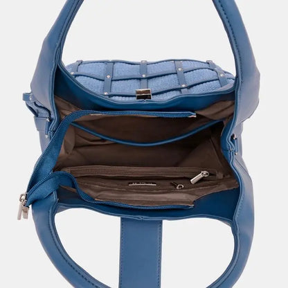 Interior of blue leather handbag with multiple compartments, zipper pockets, and brown lining. Spacious and organized design.