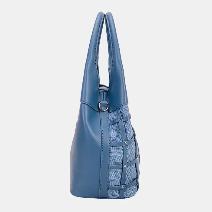 Blue leather handbag with woven side panel, metal studs, and adjustable strap. Versatile design for various occasions.