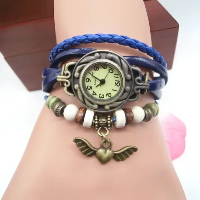 Blue leather bracelet watch with antique heart charm, decorative beads, and vintage bohemian design.