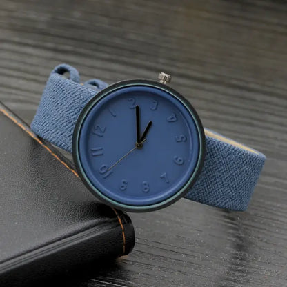 Stylish blue wristwatch with a textured strap and embossed dial, perfect for casual modern fashion.