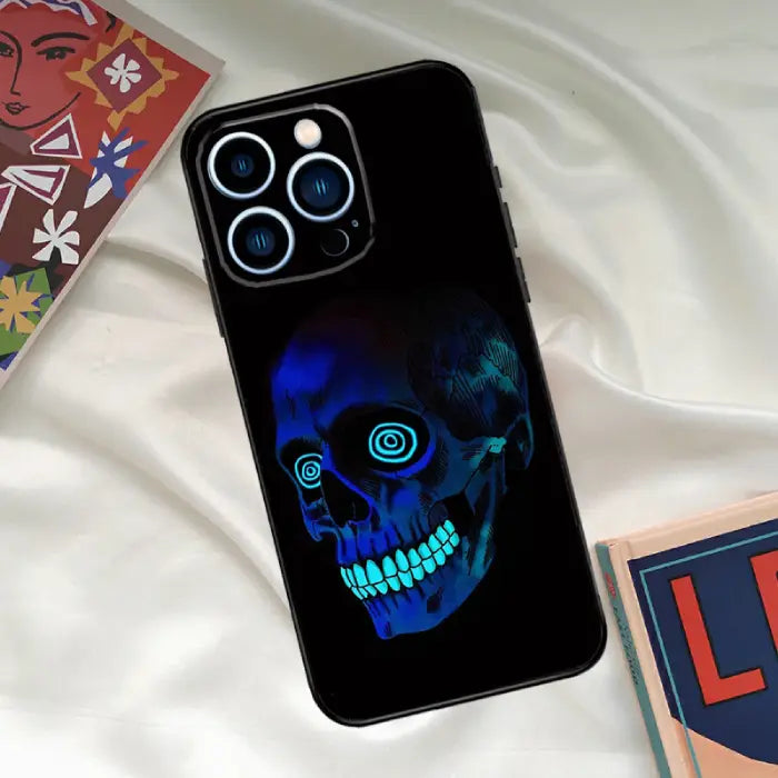 Blue neon skull phone case with glowing eyes and teeth, perfect for fans of futuristic designs.