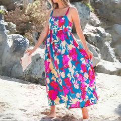 Blue pink floral maxi dress full length showing smocked fit and bold flower print.