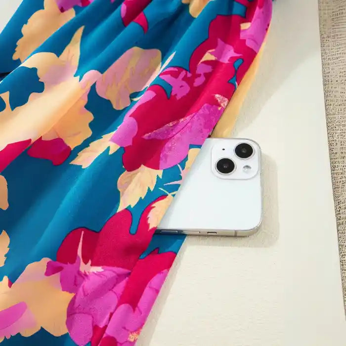 Blue pink floral maxi dress hanging with smocked bodice and flowing skirt visible.