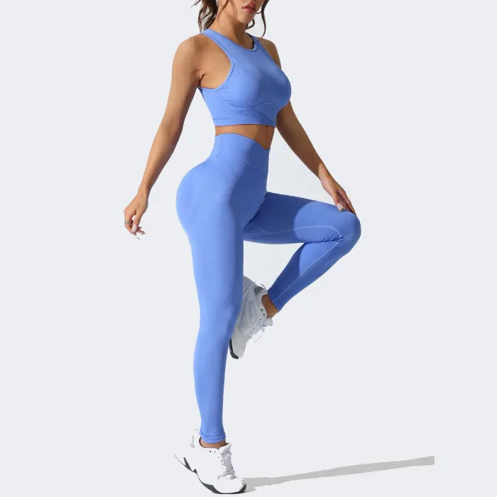 Dynamic pose in blue seamless activewear set, featuring stretchable fabric for versatile exercise routines.