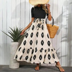 Boho maxi dress black beige pattern tied waist fluttering tiered hem perfect for summer outings.
