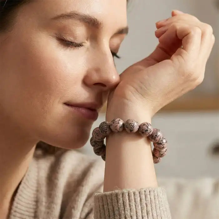 Botanical scented beaded bracelet herbal with brown marbled beads, shown worn on wrist in natural light.