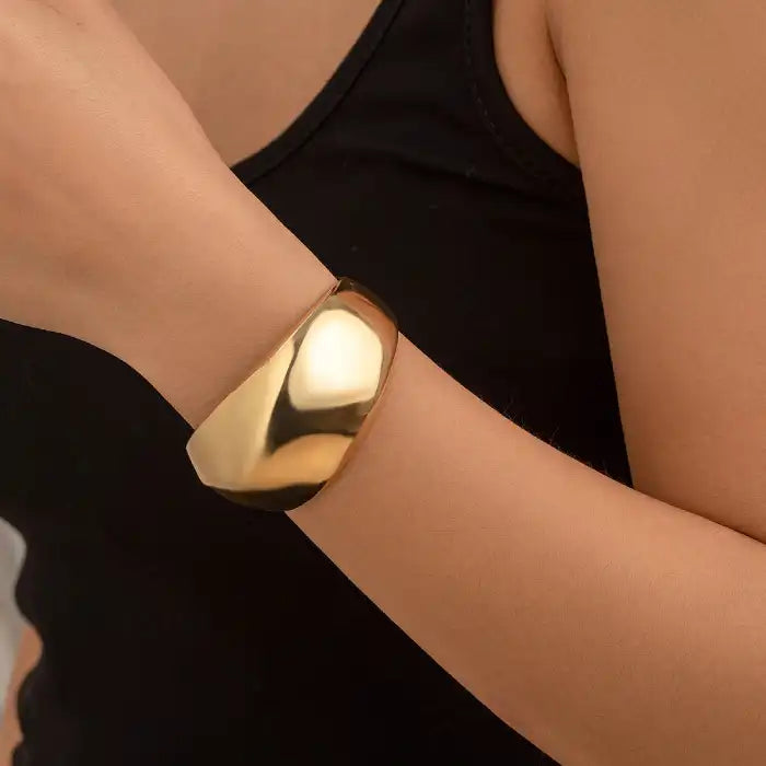 bracelet fashionable sculpted gold bangle shown on wrist