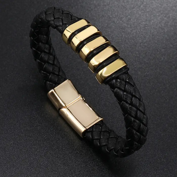 Black braided leather bracelet with gold magnetic clasp and accents for stylish men’s wristwear.