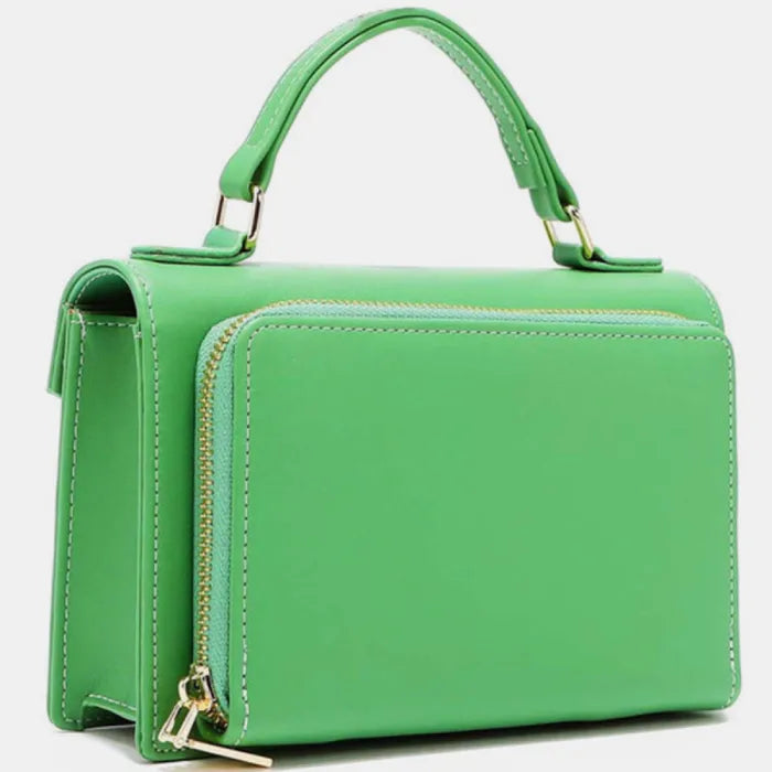 Bright green leather handbag side view, showcasing zipper detail, structured shape, and top handle attachment