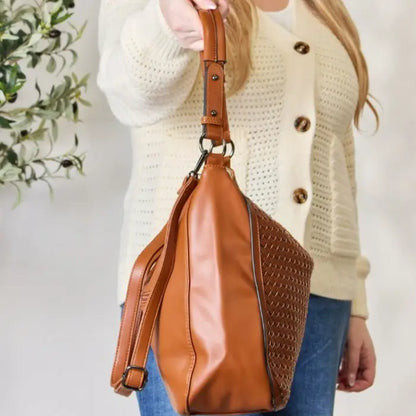 Side view of a fashionable woven leather purse in brown.