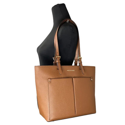 Michael Kors Brown leather tote bag displayed on mannequin, showing its chic and fashionable look.