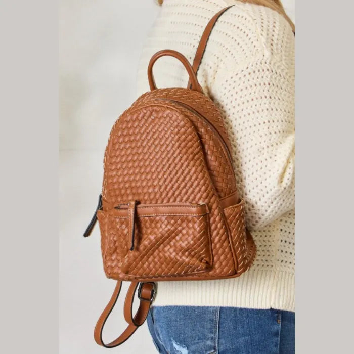  Brown woven leather backpack worn by a woman in casual outfit, ideal for everyday use.