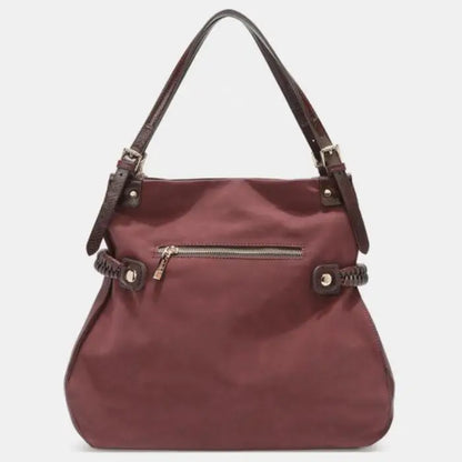 Back view of burgundy bag with zipper pocket and braided accents, designed for versatile use.