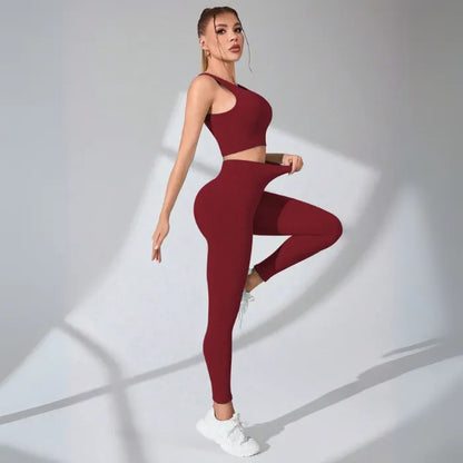 Burgundy ribbed workout set with racerback crop top and high-waisted compression leggings, paired with white sneakers