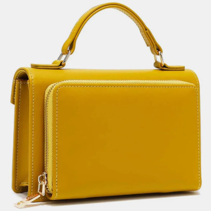 Side view of camel leather handbag displaying gold zipper detail, handle attachment, and smooth leather finish