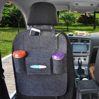 Car-back-seat-organizer with dual cup holders, phone slot, and tissue pocket attached to driver's seat.