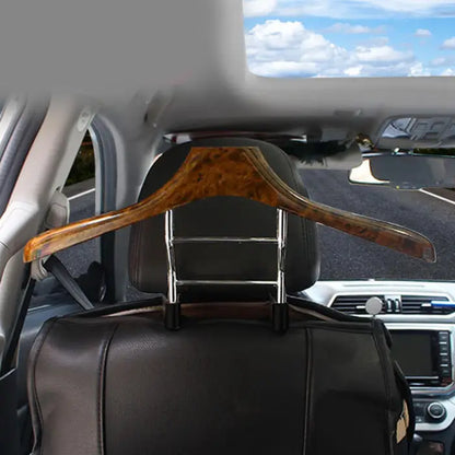 Close-up of a car coat hanger mounted on a headrest for travel.