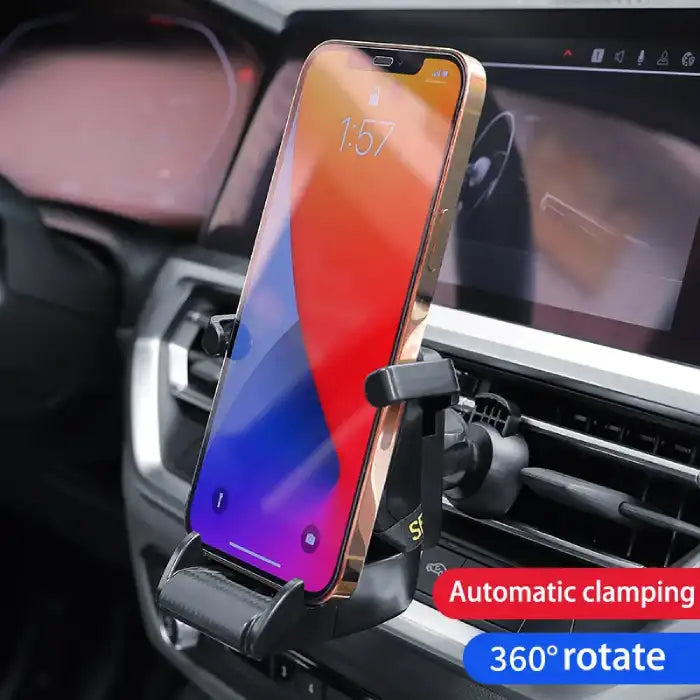 Car phone holder with automatic clamping and 360° rotation mounted on vehicle dashboard air vent.