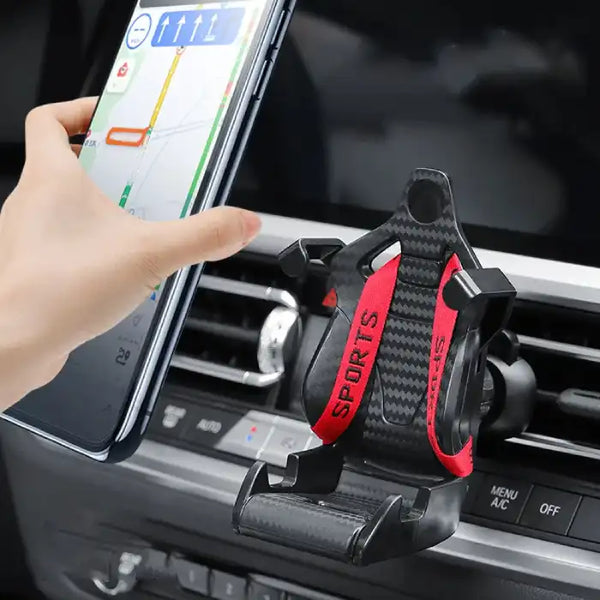 Car phone holder with red sports-style straps mounted on dashboard vent for secure smartphone grip.